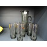 A vintage black glass Sangria jug or pitcher and glass set