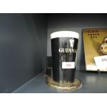 A vintage bar advertising light for Guinness Irish beer