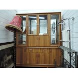 A vintage lounge unit having glazed top over sideboard base