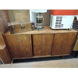 A vintage teak bookcase having sliding doors