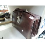 A vintage brown leather bound satchel bag