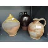 A selection of vintage art house and earthen ware pottery including money box and jug