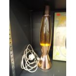 A vintage 1970's style lava lamp with copper effect base and top