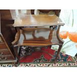 An Edwardian mahogany occasional table having shaped top on larger undertier and shaped legs