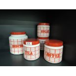 A selection of vintage pressed glass kitchen containers in white and red