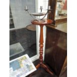 A reproduction torchere stand and modern arts and crafts style 3 branch candlestick