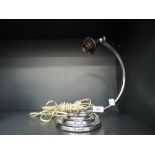 A vintage art deco design lamp base with swan neck and chrome finish