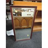 A late 20th Century mahogany effect wall mirror