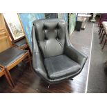 A vintage designer egg style chair in black pvc on chrome revolving base