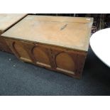 A traditional stripped pine blanket box, having gothic panelling to front