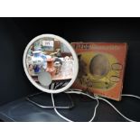 A vintage shaving mirror by Pifco with integral light and box