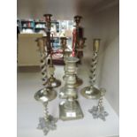 A selection of vintage brass candle sticks including twist stem, floral base and 4 tier