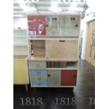 A vintage kitchenette having glass display section with fish decoration