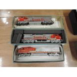 Three Athearn HO scale American brass Santa Fe locomotives in red and white livery, all boxed