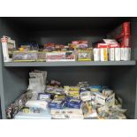 Two shelves of HO scale accessories, vehicles and kits including Trident, Woodland Scenics,