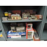 Two shelves of Walthers, Bachmann and similar HO scale kits and accessories some boxed