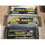 Three Athearn HO scale American brass Santa Fe locomotives in blue & yellow livery, all boxed