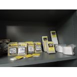 A shelf of Woodland Scenics, NuComp Miniatures HO scale accessories and Mobile home Kits, all