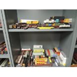 Two shelves of HO scale American rolling stock and wagon loads, approx 130 items