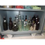 A selection of vintage advertising glass bottles including Esso lube, Emu brand etc