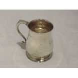 A silver christening tankard of plain baluster form having moulded scroll handle and monogram VMB to