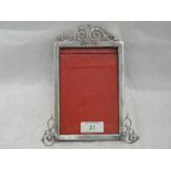 A Victorian silver photograph frame of plain rectangular form having silver wire scroll decoration