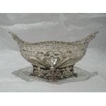 A Victorian silver basket of oval form having moulded floral rim and pedestal base with pierced