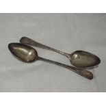 A pair of Georgian silver table spoons of plain form bearing monogram JWM to terminals, London 1802,