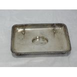 An Edwardian silver desk tidy having pen stand and indent for oval inkwell (missing), London 1905,