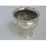 A Victorian silver sugar bowl of urn form having repousse decoration and frilled rim, Chester