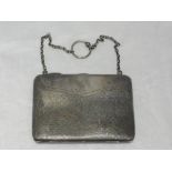 An Edwardian silver chatelaine purse having plannished and engraved decoration and green silk