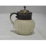 A small Georgian earthenware mustard pot having cherub and lion relief decoration, acanthus leaf