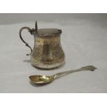 A Victorian silver mustard pot of baluster form having hinged lid, engraved scroll and floral