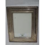 A modern silver photograph frame of rectangular form having moulded decoration, Sheffield 1994,