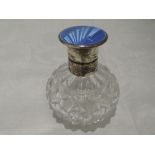 A cut glass spherical perfume bottle having silver lid with blue enamel decoration, Birmingham 1934,