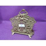 A vintage brass cast letter rack with figural design