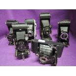 Six folding cameras. A Kodak Junior II, a Kodak No1 Pocket, a No1A pocket, a Kodak Six-20 Junior, an