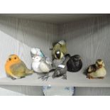 A selection of vintage bird figures and figurines including cast iron, ceramic and resin