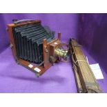 A Thornton Pickard Compact mahogany field camera with brass lens and tripod