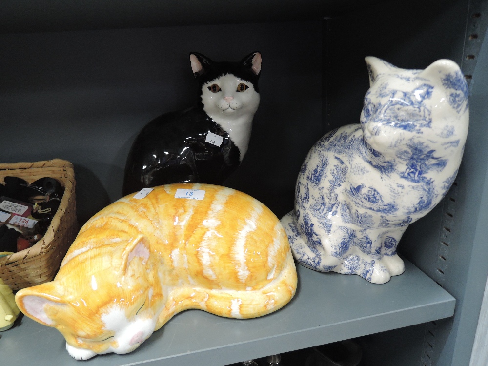 Three vintage ceramic cat figures one black and white tabby a ginger cat and transfer printed blue