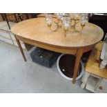 A vintage teak effect extending oval dining table