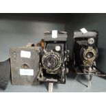 Two folding cameras and a box camera. An ensign Selfix 20, a Kodak No2 folding Autographic Brownie