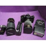 A Canon A1 35mm camera with Tokina 35-200mm zoom lens, Power winder, Tamron 80-210mm lens,