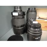 Three Sigma Camera lenses. A Sigma 70mm DC Macro, a mirror telephoto and a DL Macro super 70-300mm