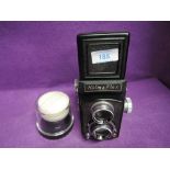 A Halma Flex Refex camera and an EL-Nikkor 50mm lens boxed