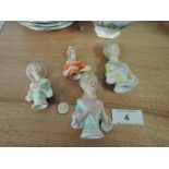 A selection of vintage ceramic figural pin cushion tops