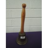 A vintage brass cast bell with treen handle