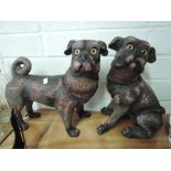 A pair of vintage pug dog figures one seated and one standing