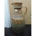 A large continental pottery jug having moulded leaf and swirl decoration, stamped Jasba 1680 55