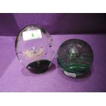 Two glass paper weights with decorative splash and swirl designs